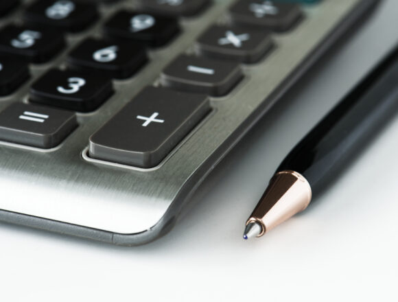 CLoseup of calculator with pen Unlocking Opportunities in South Africa’s Financial Services Skills Pipeline