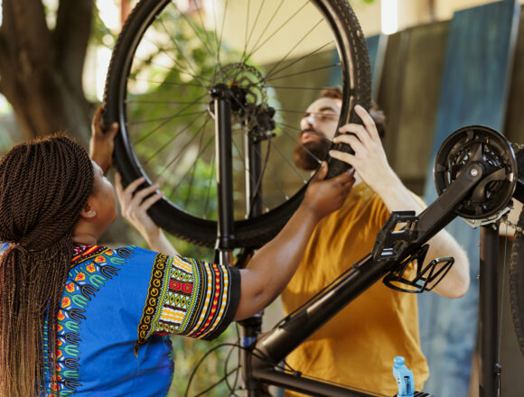Energetic couple dismantling bicycle Empowering Culture, Tourism, and Hospitality for Inclusive Growth
